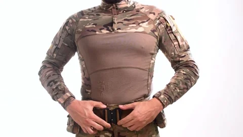 Man in combat camouflage puts on a war belt and buckles it up. Stock Footage 158012154