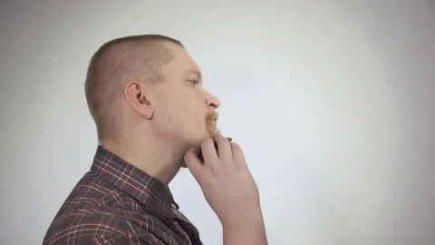Man combing the beard comb on white background, shot close-up Stock Footage 74763530