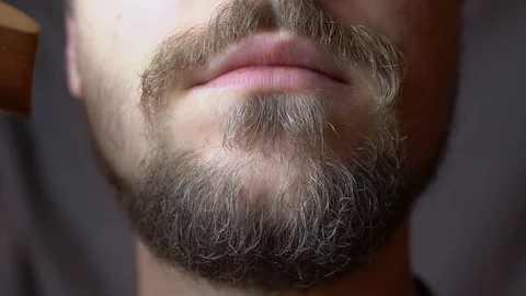 A man combing his beard with a comb in the studio Stock-Footage 124257944