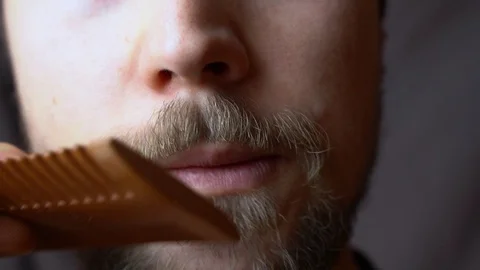 A man combing his mustache with comb Stock-Footage 124095682