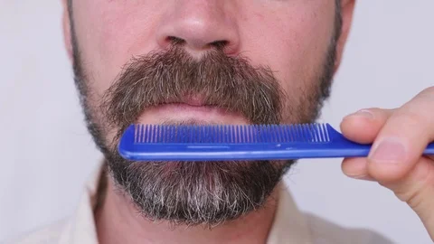 A Man Combs His Gray Beard Stock Footage 105264826