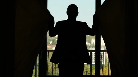 Man come to window and shut black blind curtains, close view Stock Footage 86483221