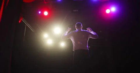 Man comedian clapping hands with audience on stage after sucsessful performance. Stock Footage