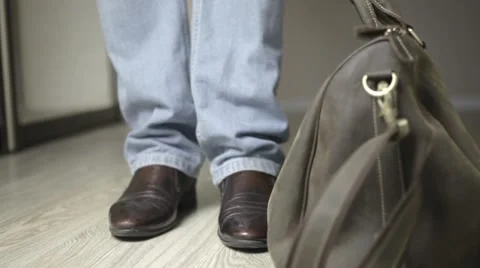 A man comes back home and takes off his shoes Stock Footage 54528052