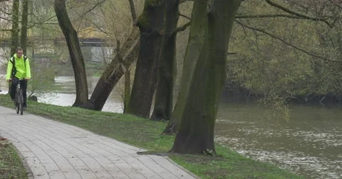 Man Comes by Bicycle Clicks a Tablet in Park Backpacker Riding a Bicycle and Stock Footage 62186657