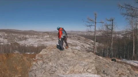 The man comes to the cliff. Preparing to jump from the top of the cliff. Stock Footage 87913314