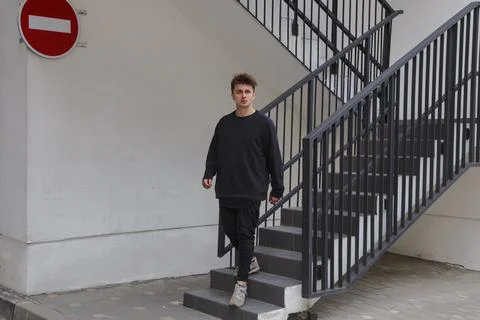A man comes down the stairs. Stock Photos