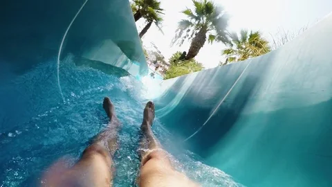 Man comes down from a water slide. First person view in slow motion Stock Footage 99515536