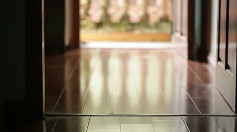A man comes inside a house from a balcony Stock Footage 55710184