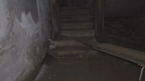 The man comes out of the dark old basement and climbs the stairs Stock Footage 150056353