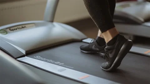 Man comes to the running machine in the gym Stock Footage 56635919