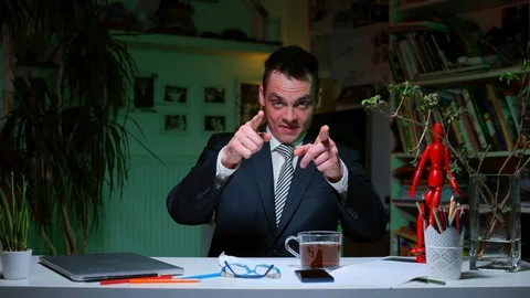 A man comes to the table and starts the home office in the evening. COVID 19. Stock-Footage 128027254