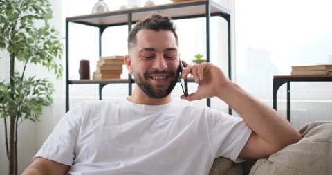 Man on comfortable sofa using mobile phone call Stock Footage 150025867