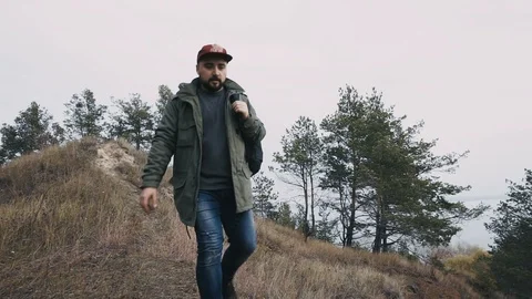 Man coming down from the mountain to the camera. Long shot Stock Footage 97792201