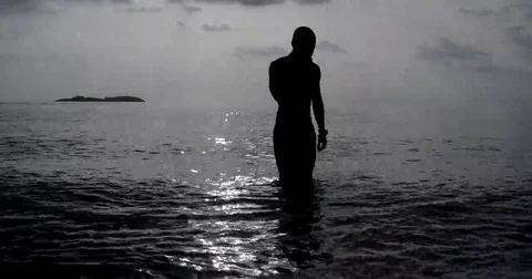 Man Coming Out of the Sea at Sunset Stock Footage 69243003