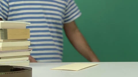 Man Coming to White Table, Reading a Letter with Green Screen Background Vídeos de archivo 344677486