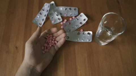 A man commits suicide. Takes a lethal dose of pills Stock Footage 97975594