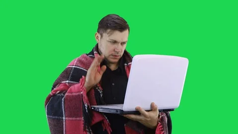 A man communicates remotely on a laptop showing his interlocutor that he is sick Stock Footage 128327984