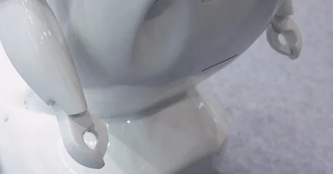 A man communicates with a robot, presses a plastic mechanical arm to the robot Stock Footage 76957102