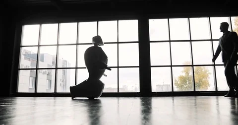 A man communicates with a robot, presses a plastic mechanical arm to the robot Stock Footage 80419178