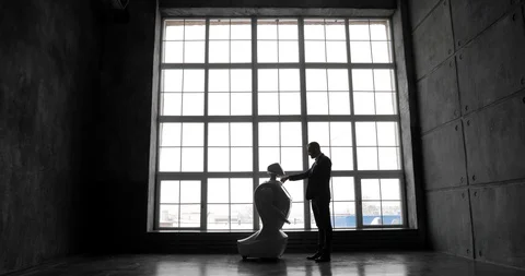 The man communicates with the robot, will sew his hand. Against the background Stock Footage 97968059