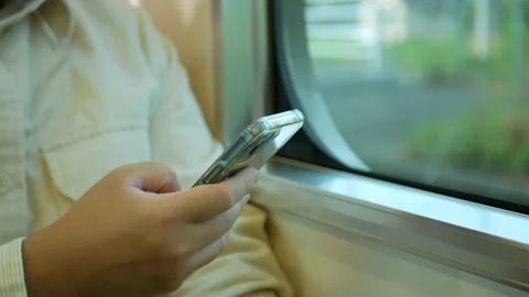 A man in a commuter train subway metro traveling and uses the smartphone ha.. Stock Footage 232396599