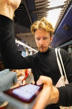 Man commuting on subway using smartphone technology Stock Photos