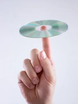 Man with compact disc on finger Stock Photos