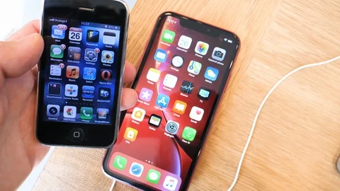 Man compares Apple Computers iPhone 3gs vs Xr Stock Footage 97538823