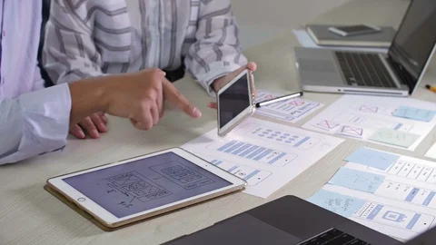 Man Comparing Charts on Two Gadgets Stock Footage 99673403