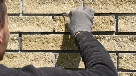 Man completes the work on the wall cladding Video stock 153415778