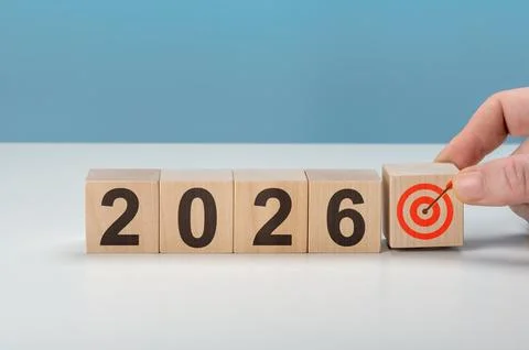 Man completing 2026 with target icon cube. Represents finishing business plan Stock Photos