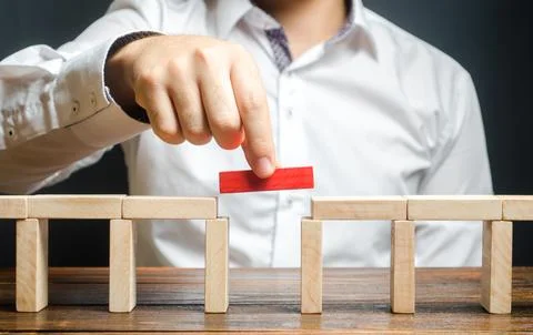A man is completing the construction of a bridge. Build bridges, make conne.. Stock Photos