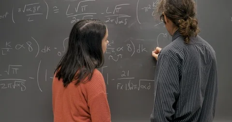 Man completing a difficult formula with a young woman - wide shot Video stock 106076037