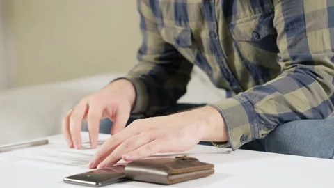 Man completing a form or paperwork before making payment Stock Footage 166216018