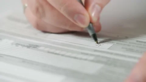 Man completing a form or signing a legal document Stock Footage 166216130