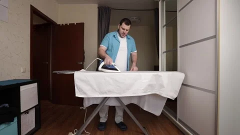 Man Completing Laundry and Ironing Task in Home Environment, Casual Domesti.. Video stock 307757348