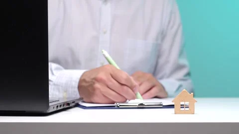 Man completing paperwork on a clipboard with a pen, signing a contract for a Stock Footage 342762394