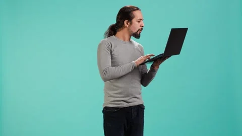 Man composing email, typing on laptop keyboard, excited to log off after work Stock Footage 319467899