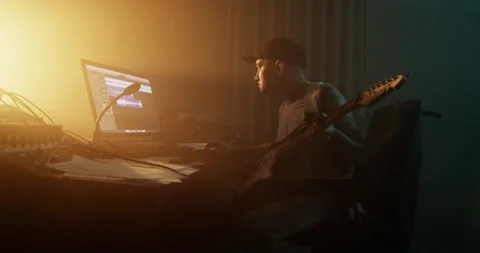 Man composing music and playing guitar in studio Stock Footage 249913039