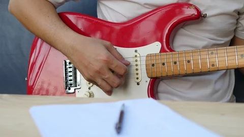 Man composing song using his guitar Video stock 100656111