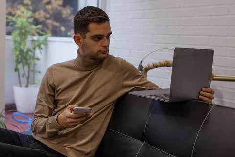 Man with computer and mobile phone at home Stock Photos