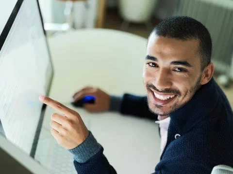 Man, computer and pointing to screen in office, web development and online for Stock Photos