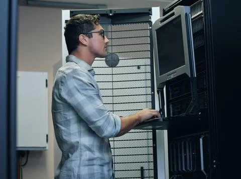 Man, computer and server room with hardware for security, firewall and safety 写真素材
