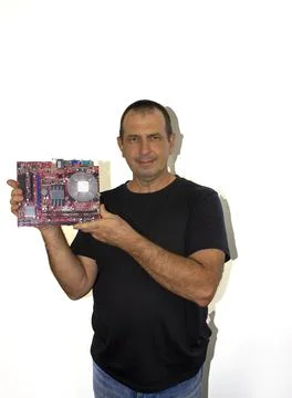 Man with a computer board, programmer, computer technician Stock Photos