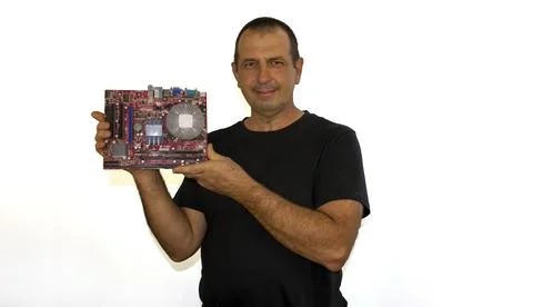Man with a computer board, programmer, computer technician Foto stock