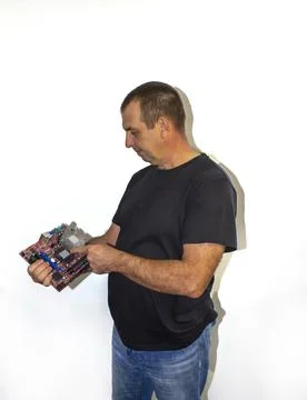 Man with a computer board, programmer, computer technician Stock Photos