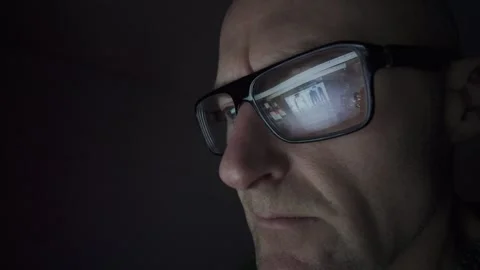 Man on computer in Dark room, screen reflection in glasses. Hull.UK. 2.1.2026 Stock Footage 327158715