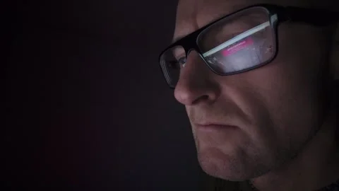 Man on computer in Dark room, screen reflection in glasses. Hull.UK. 1.1.2026 Stock Footage 327158752