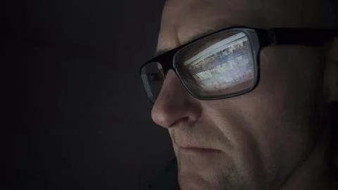 Man on computer in Dark room, screen reflection in glasses. Hull.UK. 1.2.2026 Stock Footage 327158754